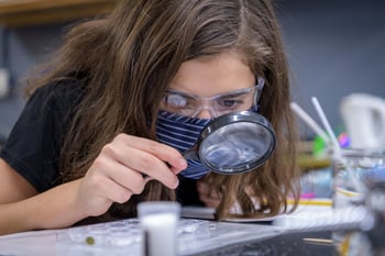 Middle school student investigates during a science lab