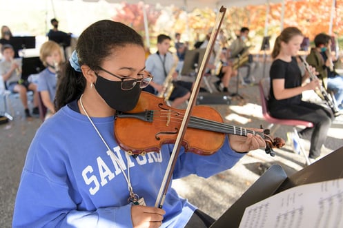 Middle School students rehearse their instruments outside