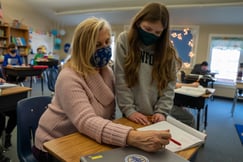 Teacher works one-on-one with student