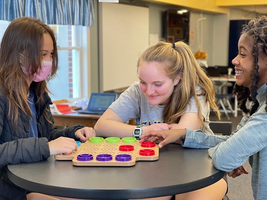 students play board game