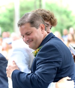 Father and son hug at graduation