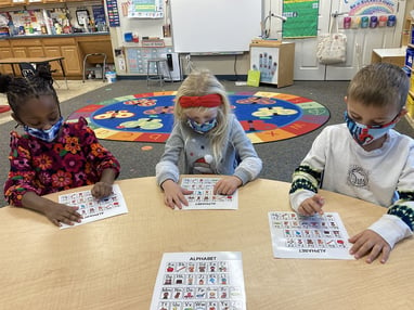 Students work in small group with teacher practicing letter sounds